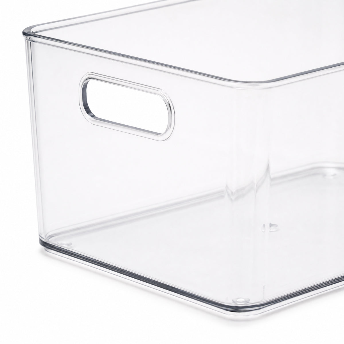 Close view of the clear storage bin handle rim and base edge