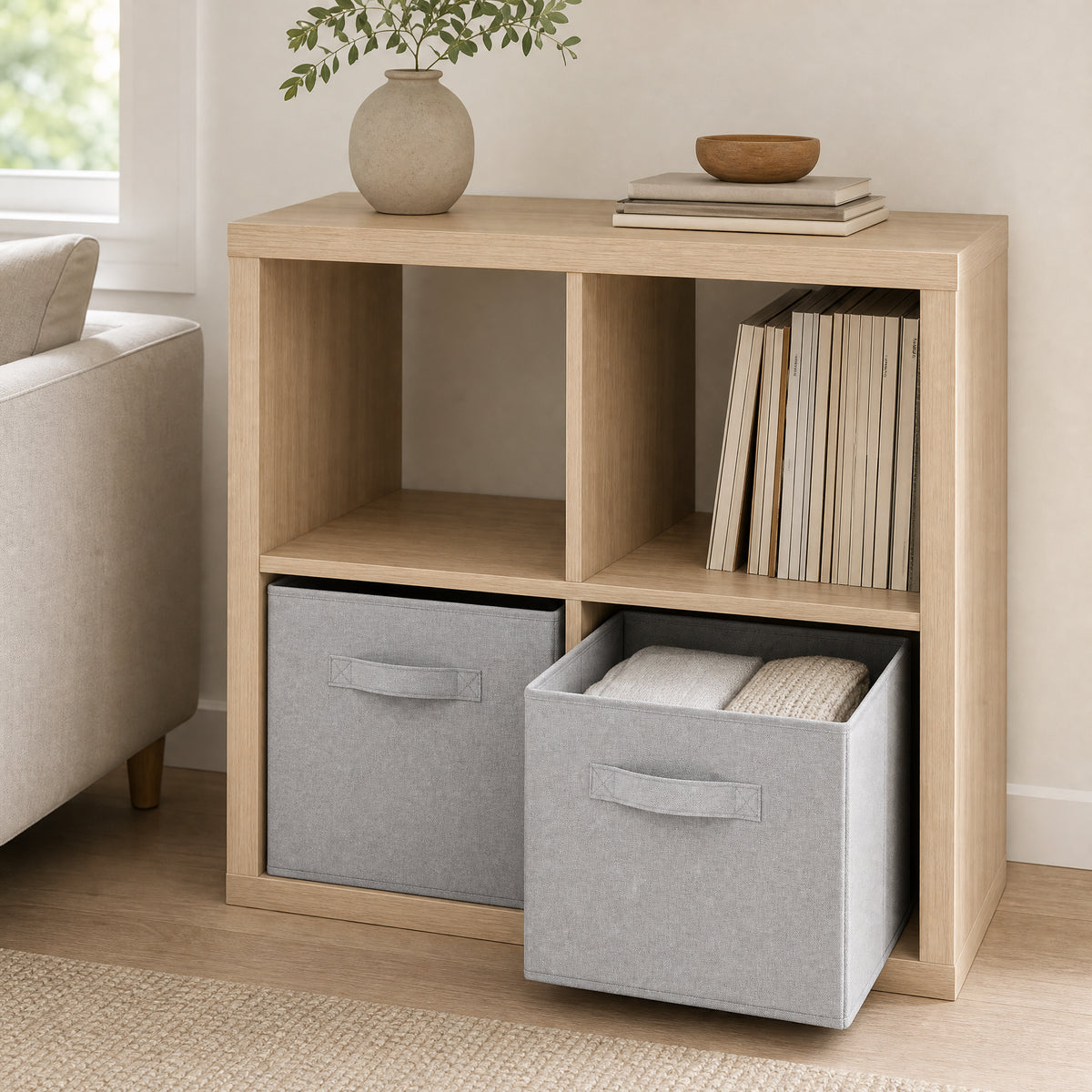 Two light-grey storage cubes shown in pale-wood cube shelving